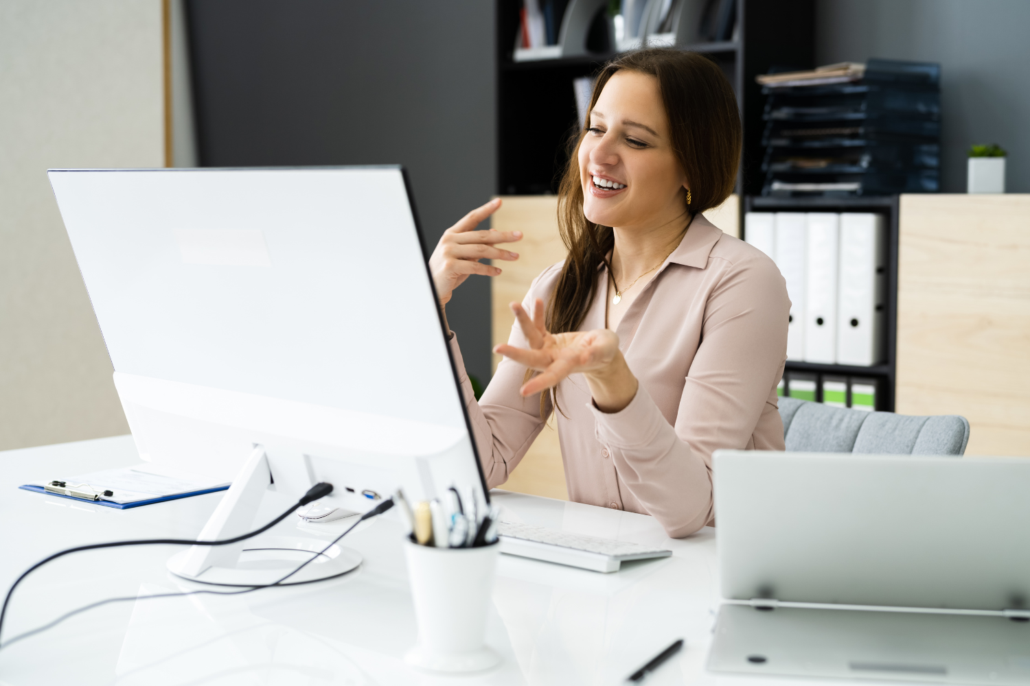 Manager explaining something on her desktop.