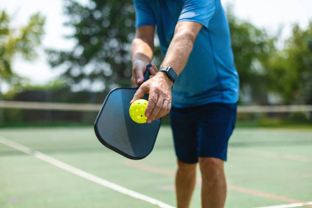 Image showing a man with a pickleball and a racket