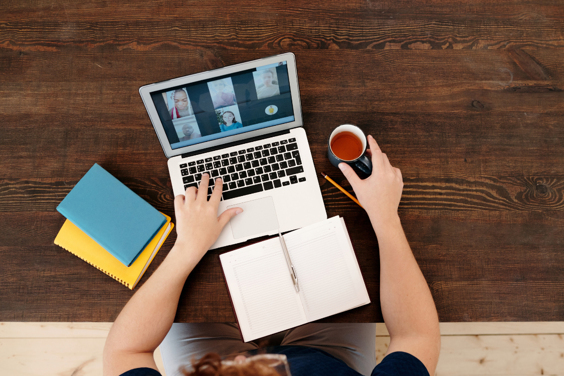 Person attending a remote team meeting with Filipino colleagues via laptop during a virtual call