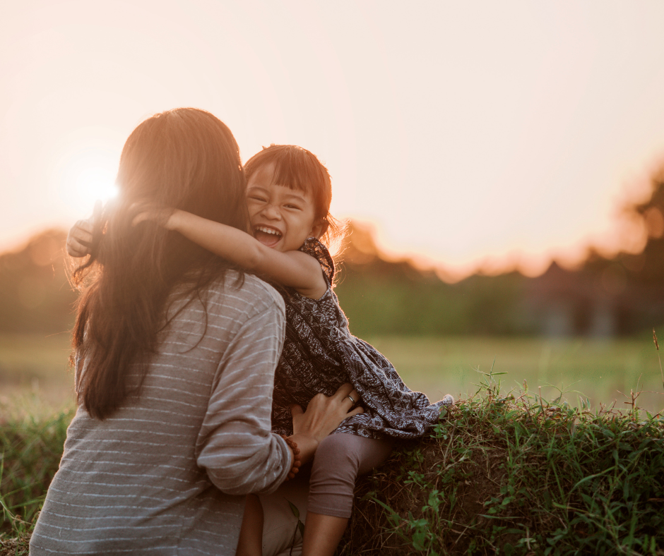 a mom and child hugging