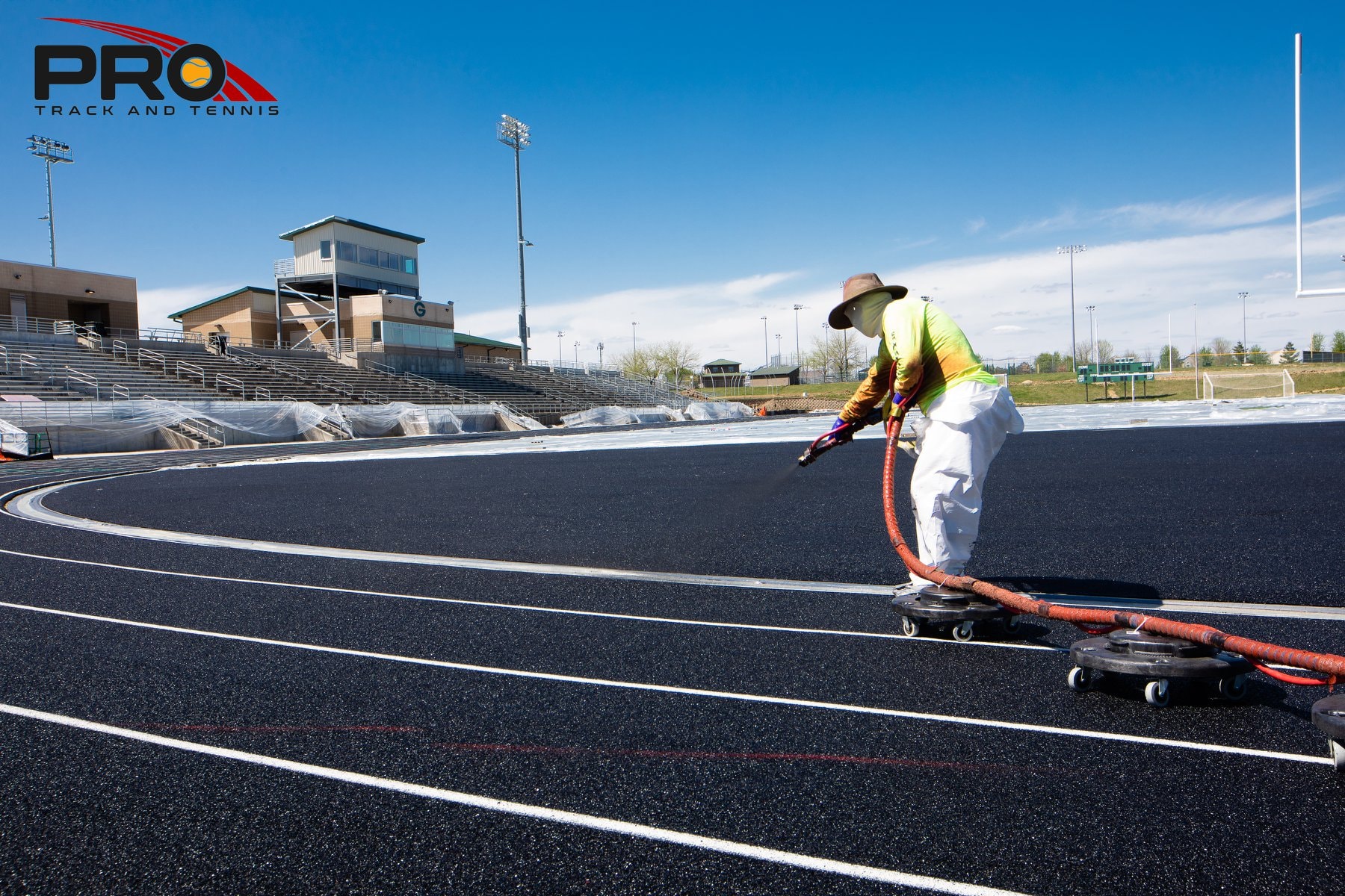Pro Track & Tennis Crew works on a newly resurfaced running track, worn out from signs of UV damage, using a Poly Structural Spray system that will make it like new!