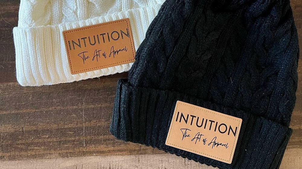 custom engraved leather hat patches on winter hats by Dawn Levitt