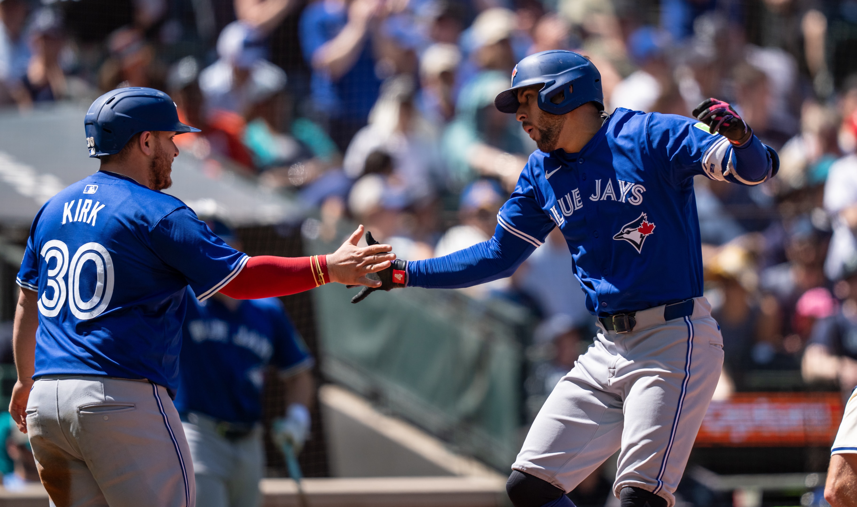 George Springer #4 of the Toronto Blue Jays is congratulated by Alejandro Kirk #30 after hitting a three-run home run during a game against the Seattle Mariners