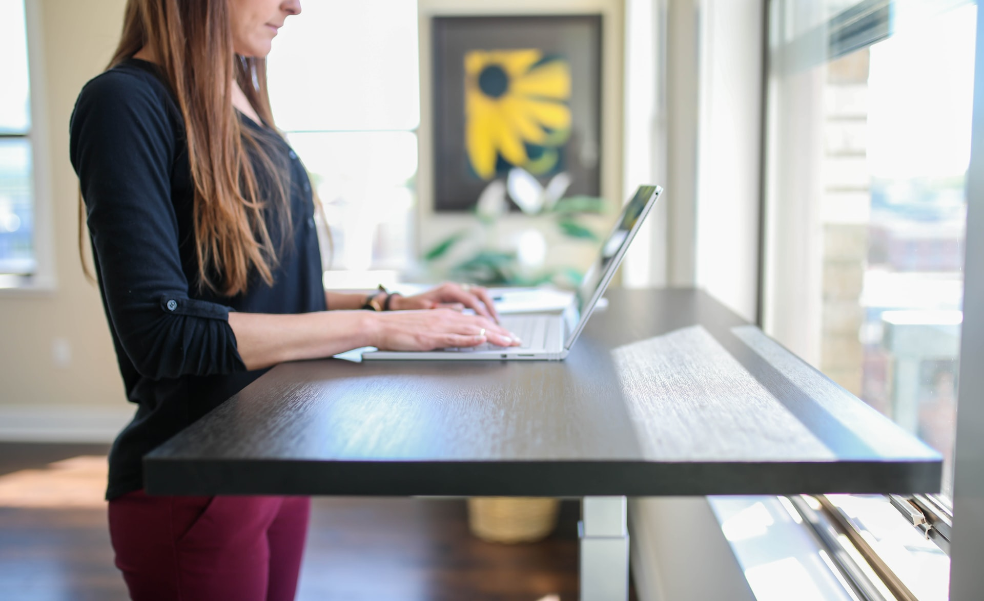 arm's length, sitting position, good posture, lumbar support, laptop stand, shoulders relaxed, eye strain, chair, work environment, 