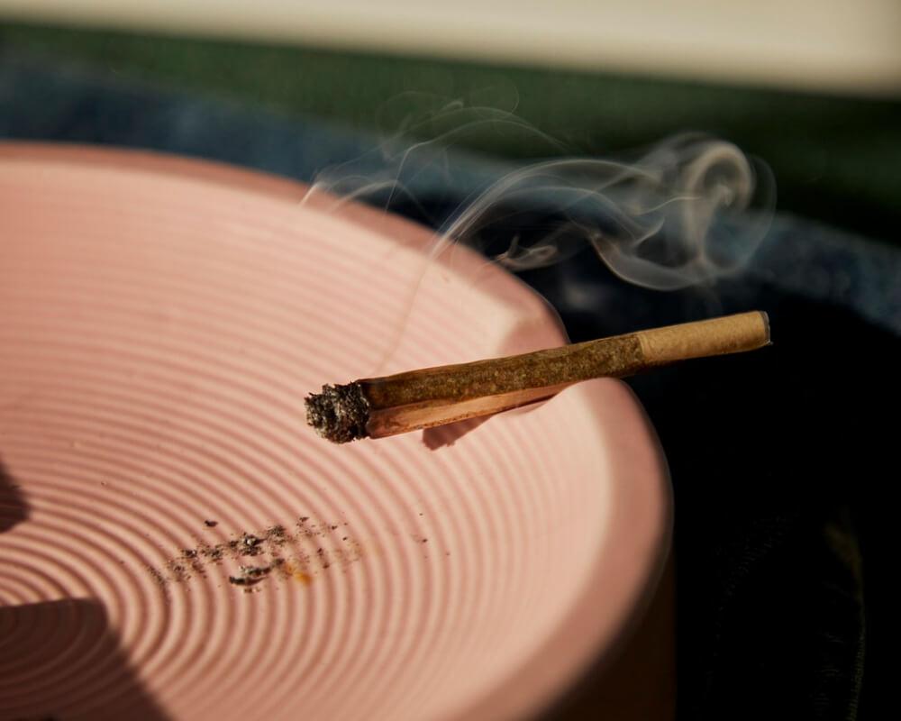 lit CBD joint on an ashtray