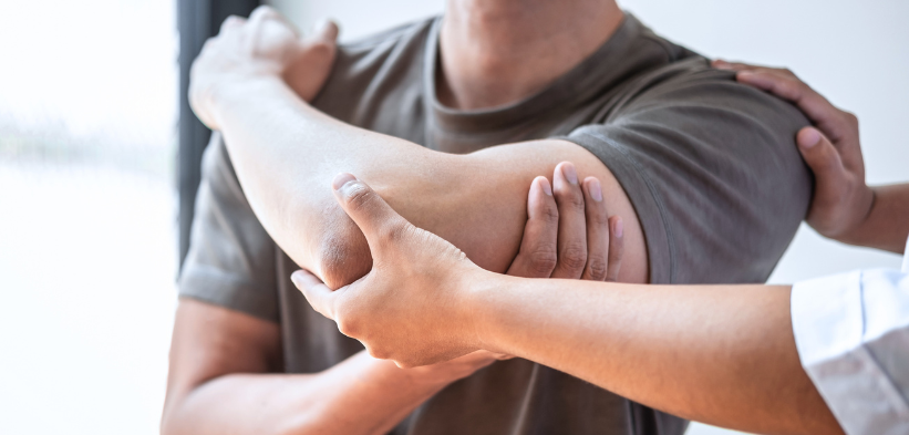 left chest pain numb arm shown by a therapist checking arm position and elbow comfort during a clinical assessment