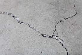 A close-up of a concrete surface with cracks