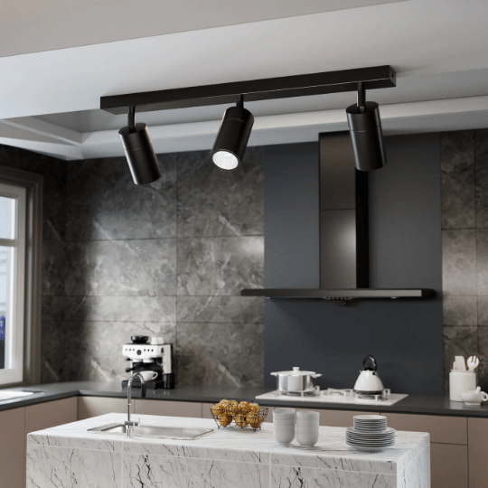 Adjustable ceiling spotlights providing task lighting as an alternative to pendant lighting in a modern kitchen