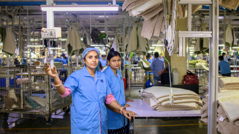 Two people working in an assembly line at a factory