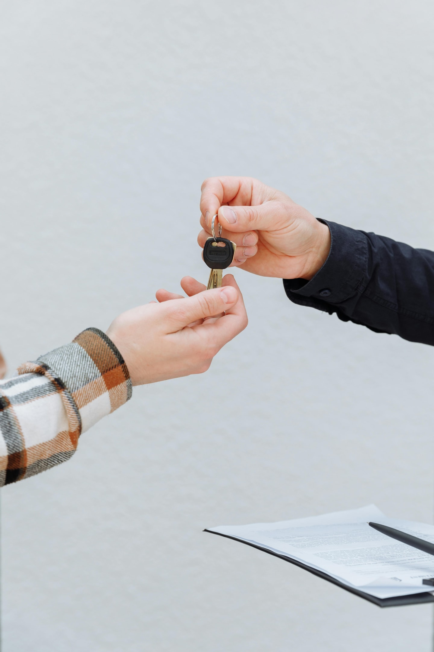 Keys being passed to real estate investor for pre-foreclosure property.