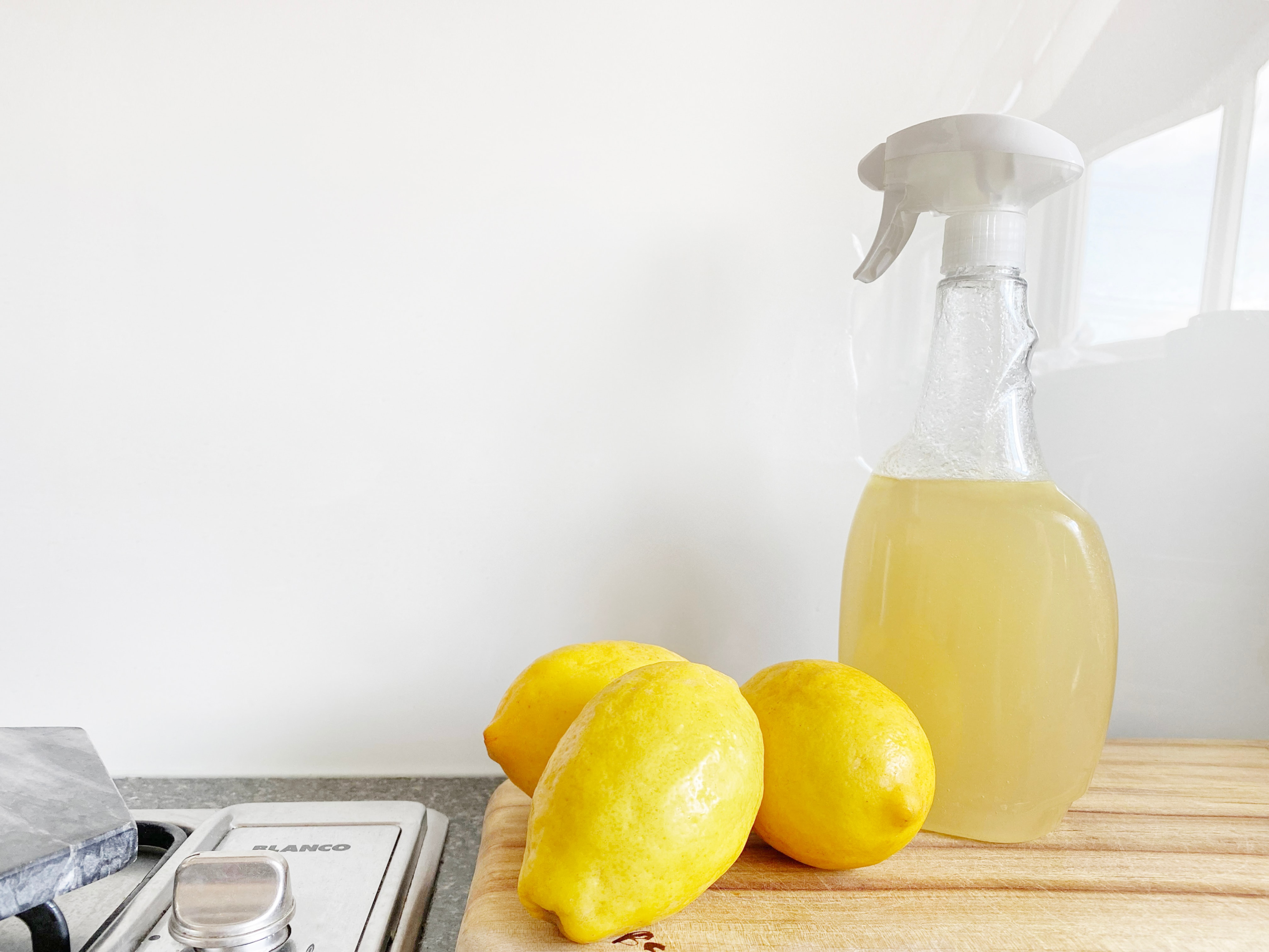 Spray bottle containing vinegar and lemon juice