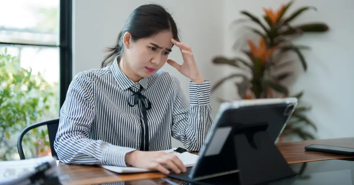 Woman reviewing a CP503 IRS notice and tax payment records at her home office.