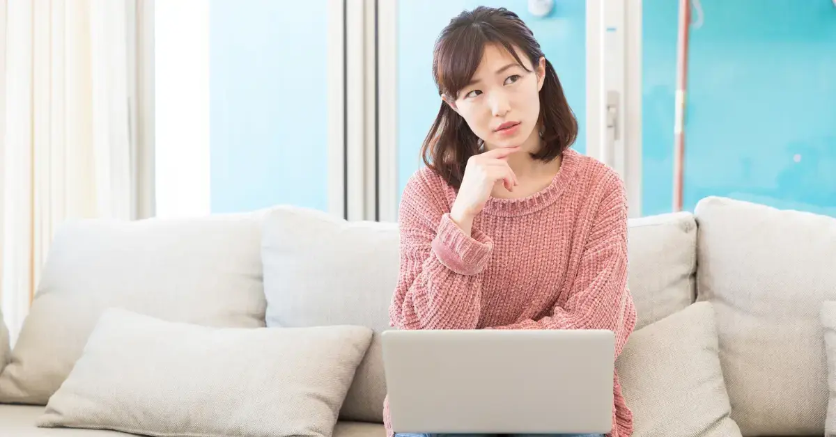 Woman thinking about OnlyFans creators tax obligations.