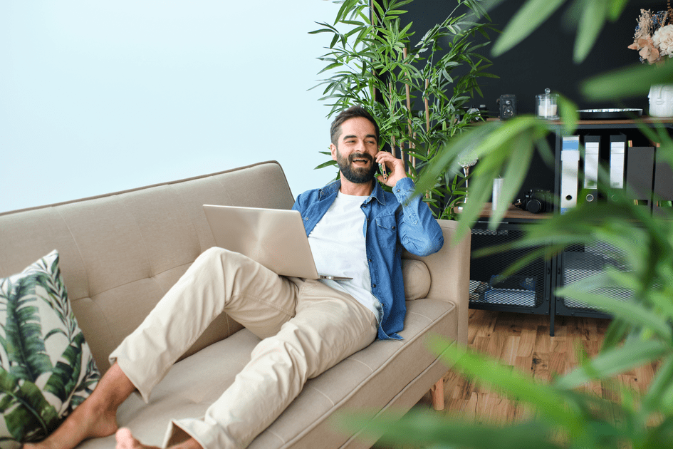 Man with ADHD using helpful technology on couch in NYC to enhance marriage communication and organization