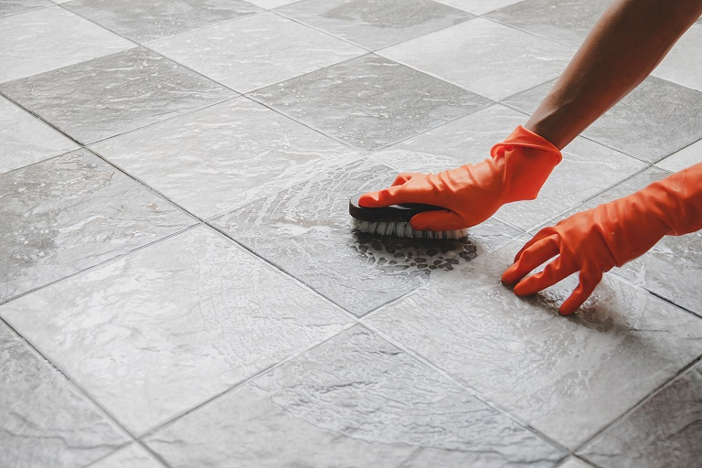 Spray the bleach solution in a spray bottle to the tile grout and stains