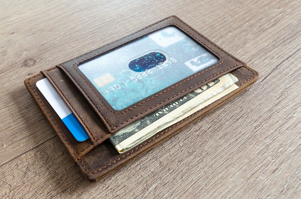 A brown leather wallet with slots for cards and bills