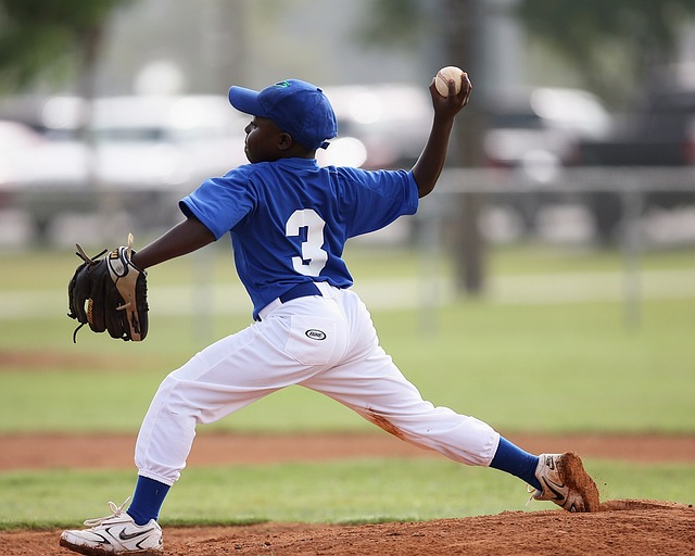 a youth baseball player throwing a baseball