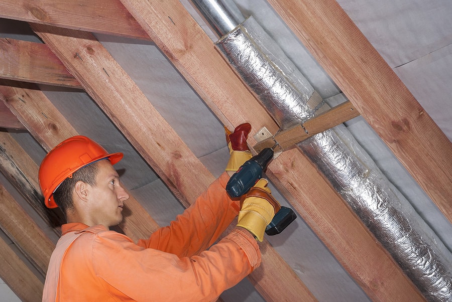 a tech conducting an air duct repair