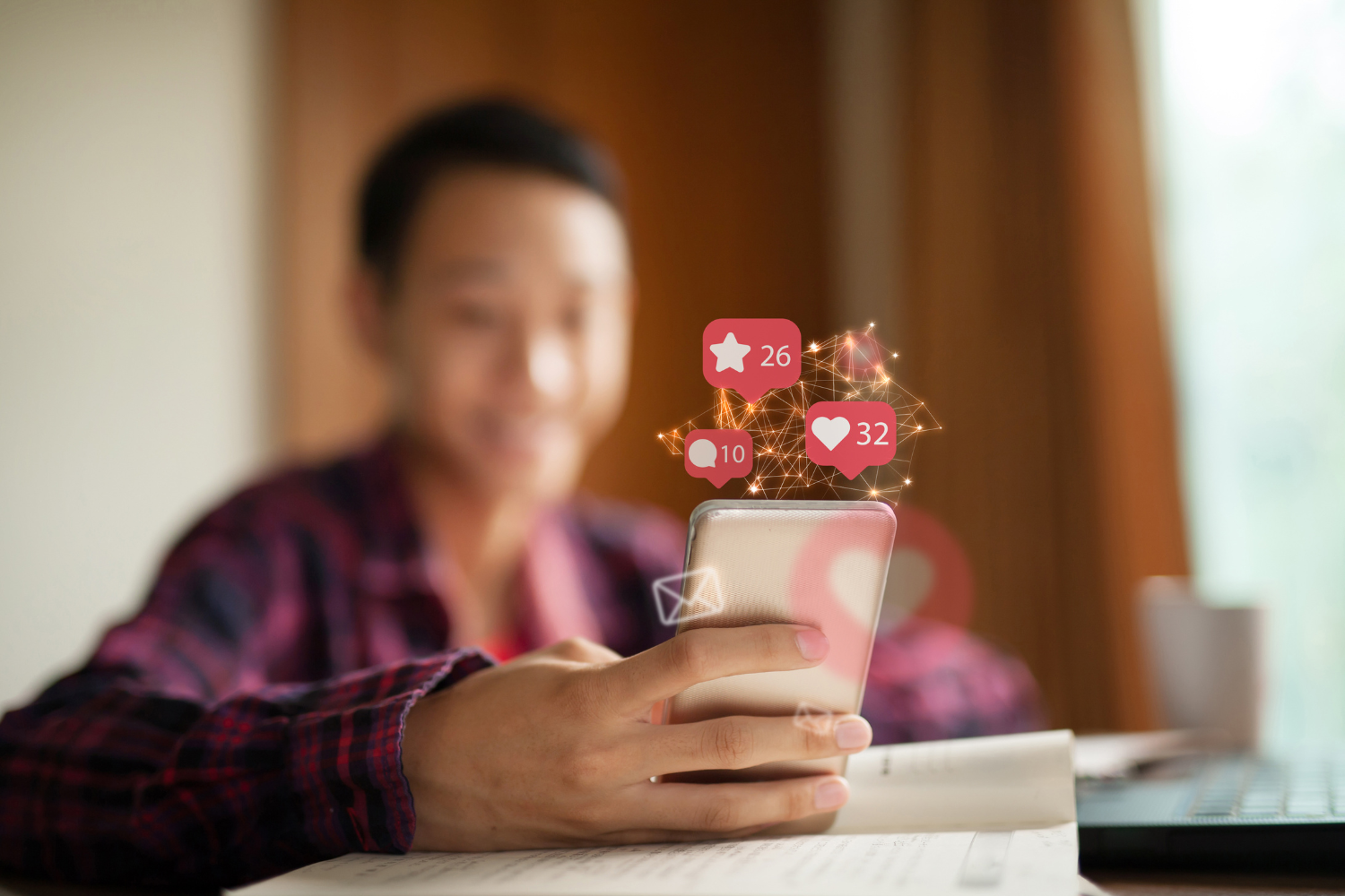 Person using a smartphone with icons for likes, star, and comments.