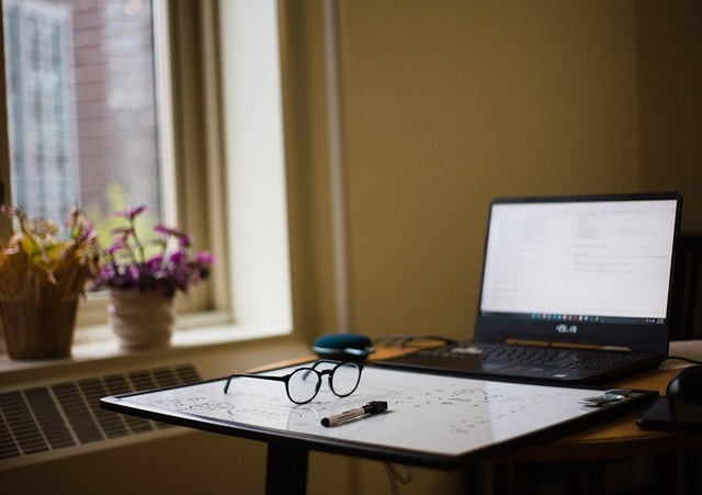A laptop on a desk showcasing online creative writing courses.