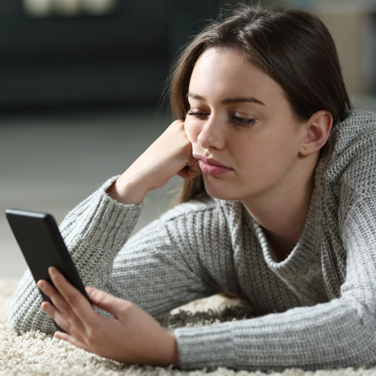 Woman bored, checking phone - Featured In : When An Ex Contacts You Years Later 