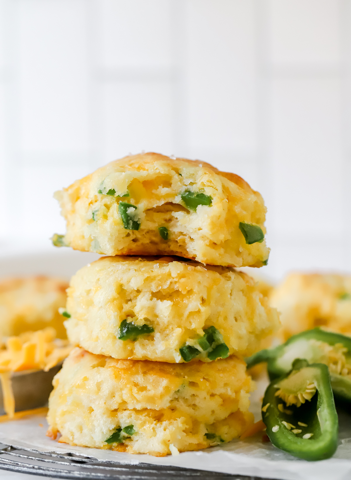 three cheddar jalapeno biscuits stacked on top of each other
