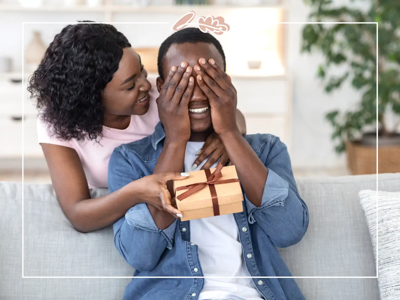 Woman covering man's eyes while giving him a gift - fabulous flowers and gifts