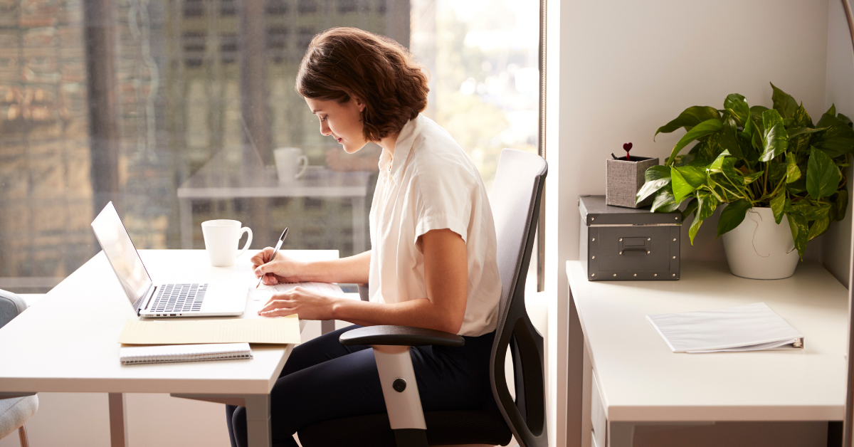 Woman at desk with laptop reviewing invoices, asking is accounts receivable an asset or liability for OnlyFans taxes.