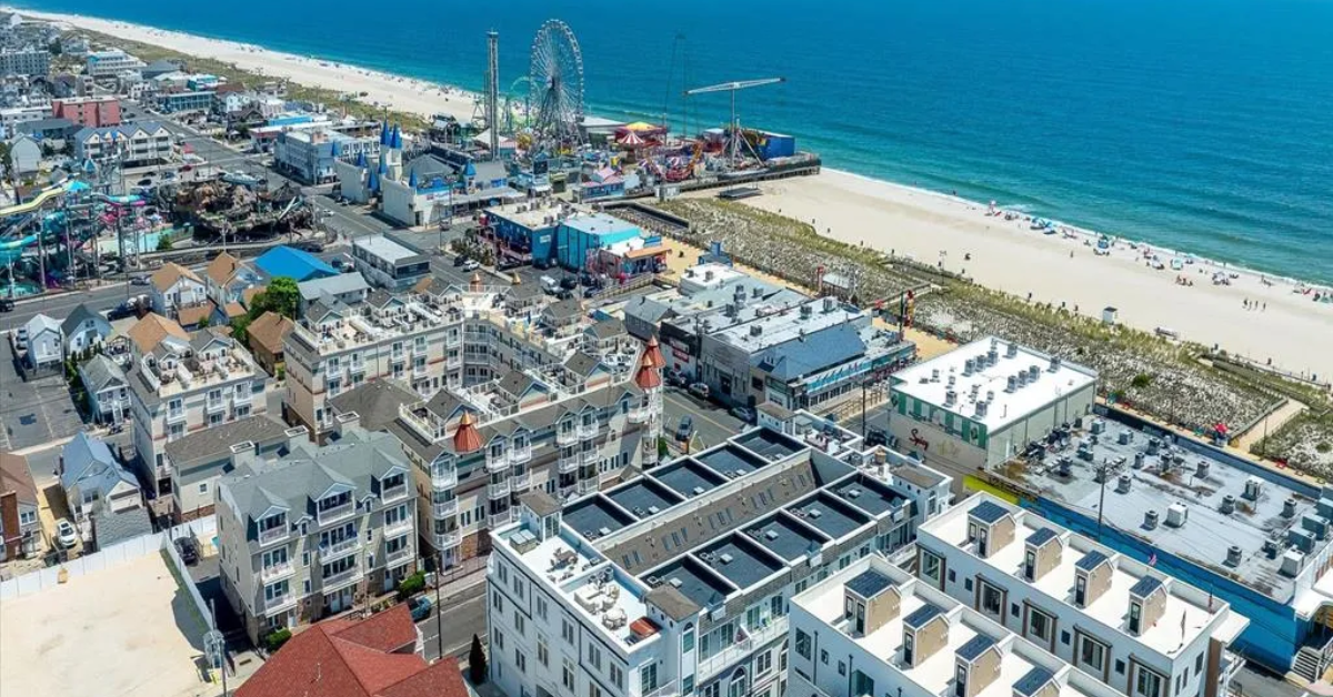 Aerial view of Seaside Heights, NJ, showcasing vacation rental homes, the world-famous Casino Pier boardwalk, and the stunning Atlantic Ocean — book direct and save up to 25% on your stay