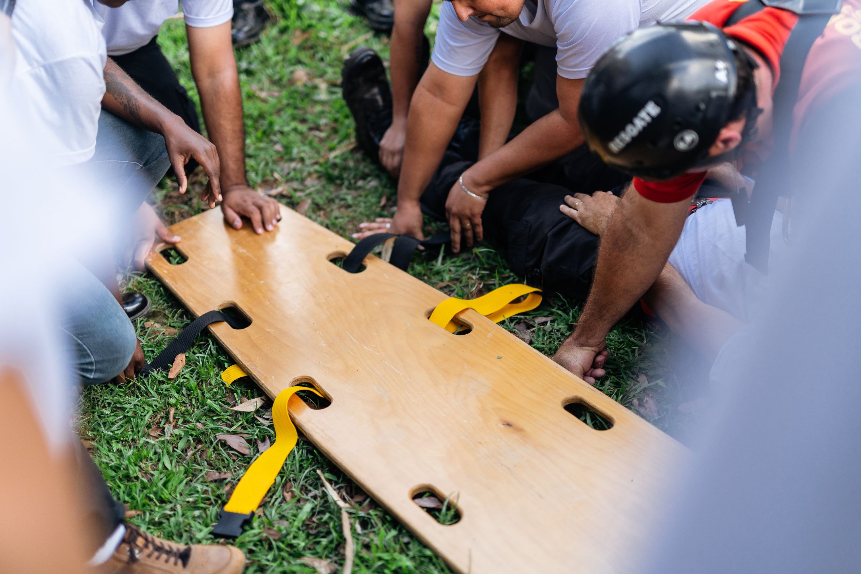 Emergency responders preparing a spinal board.