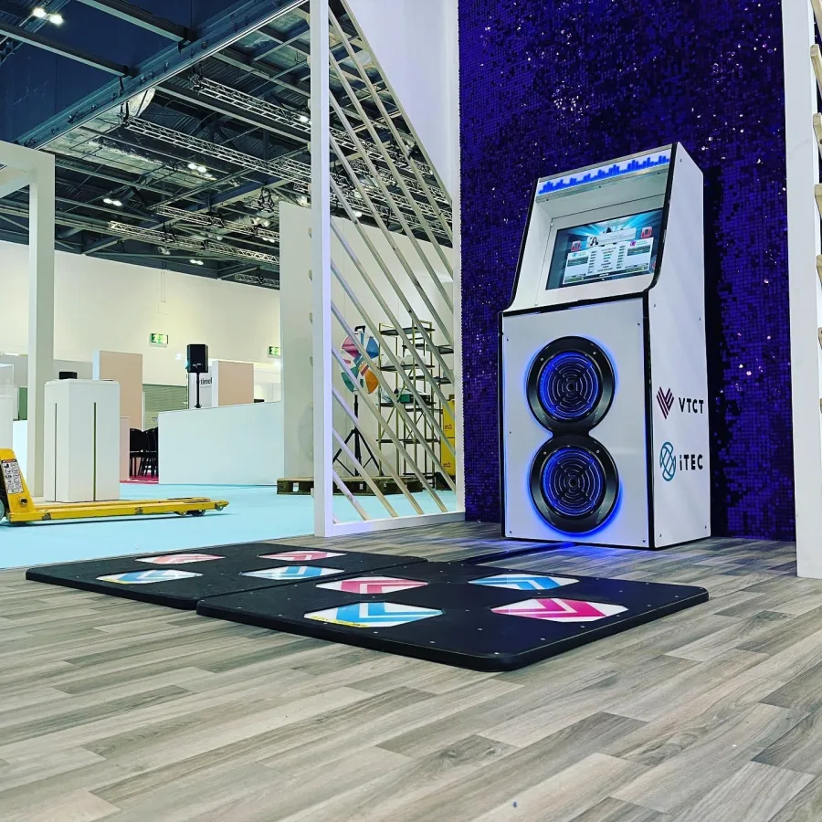 A person setting up a dance machine for an event