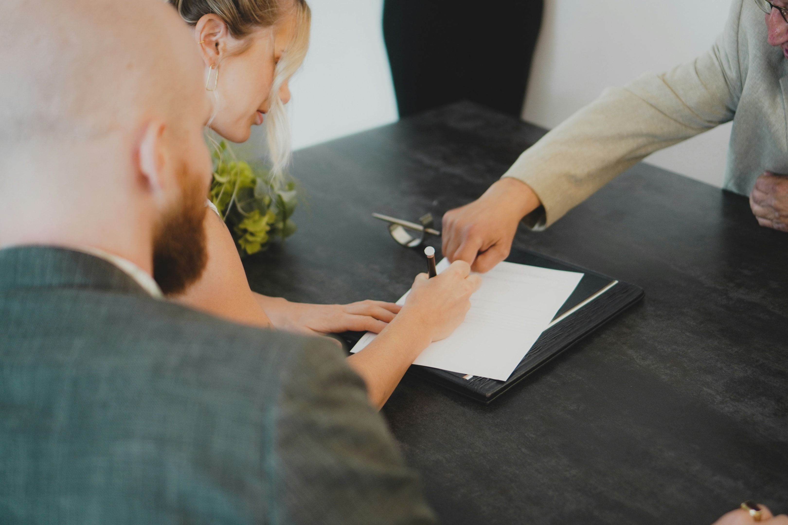 Real estate investor signs paperwork related to her real estate related IRA.