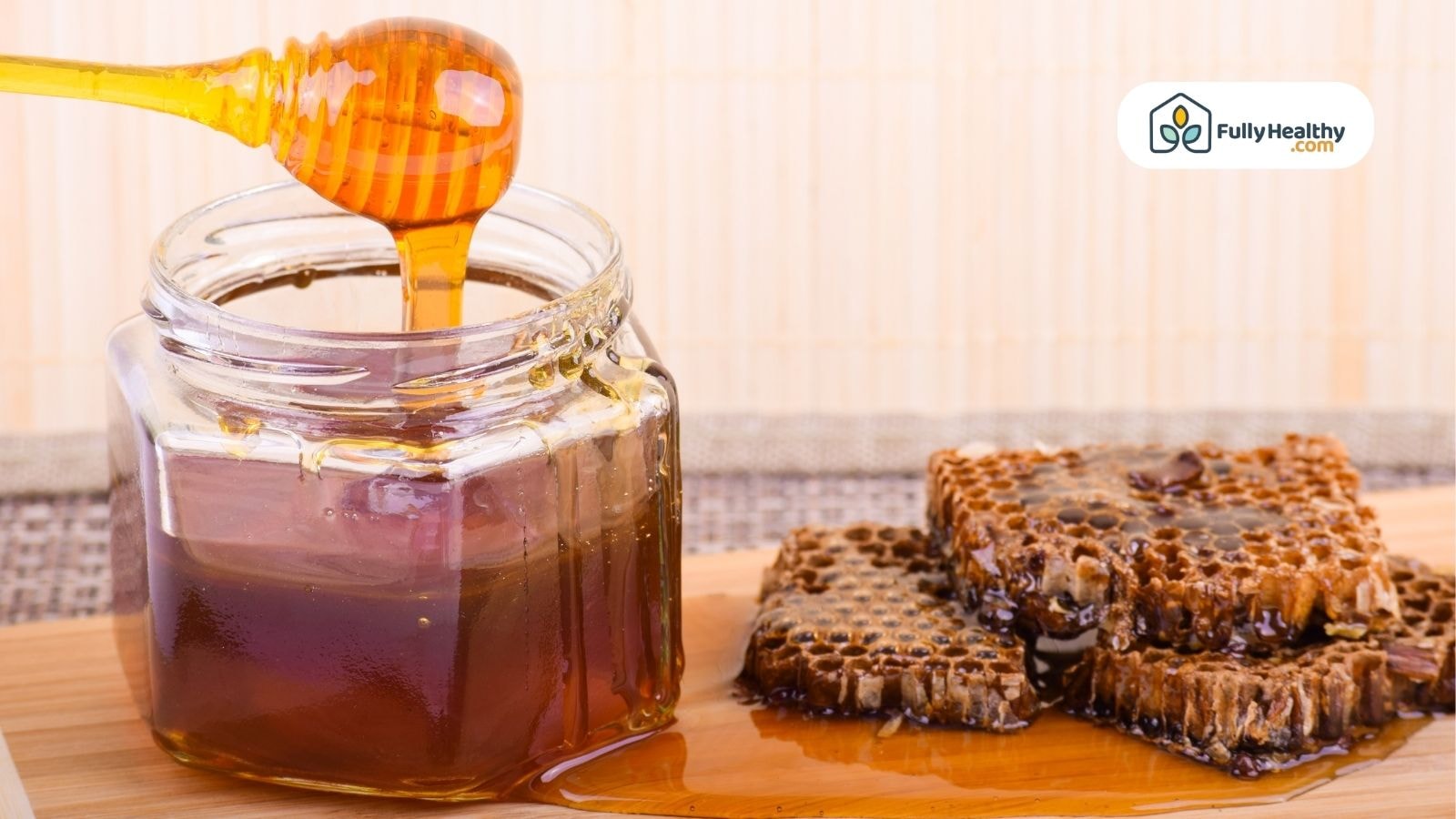 Jar of honey with honeycomb pieces beside it