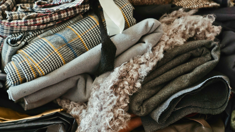 Many different types of  houndstooth clothing in a pile