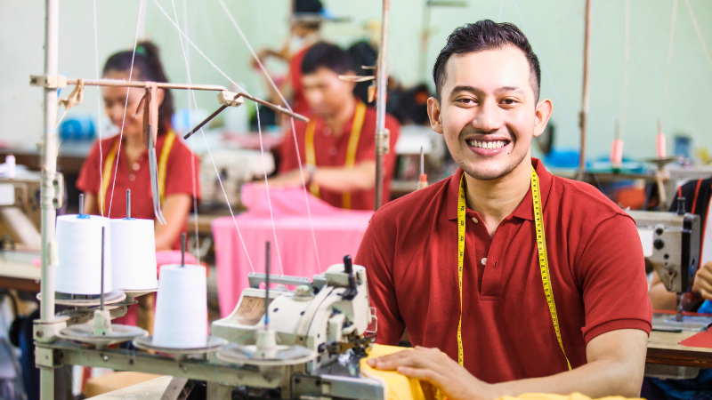 Close-up of a textile machine with bobbins of thread.