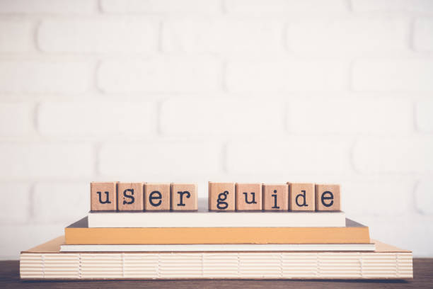 Wooden blocks spelling 'user guide' on top of books