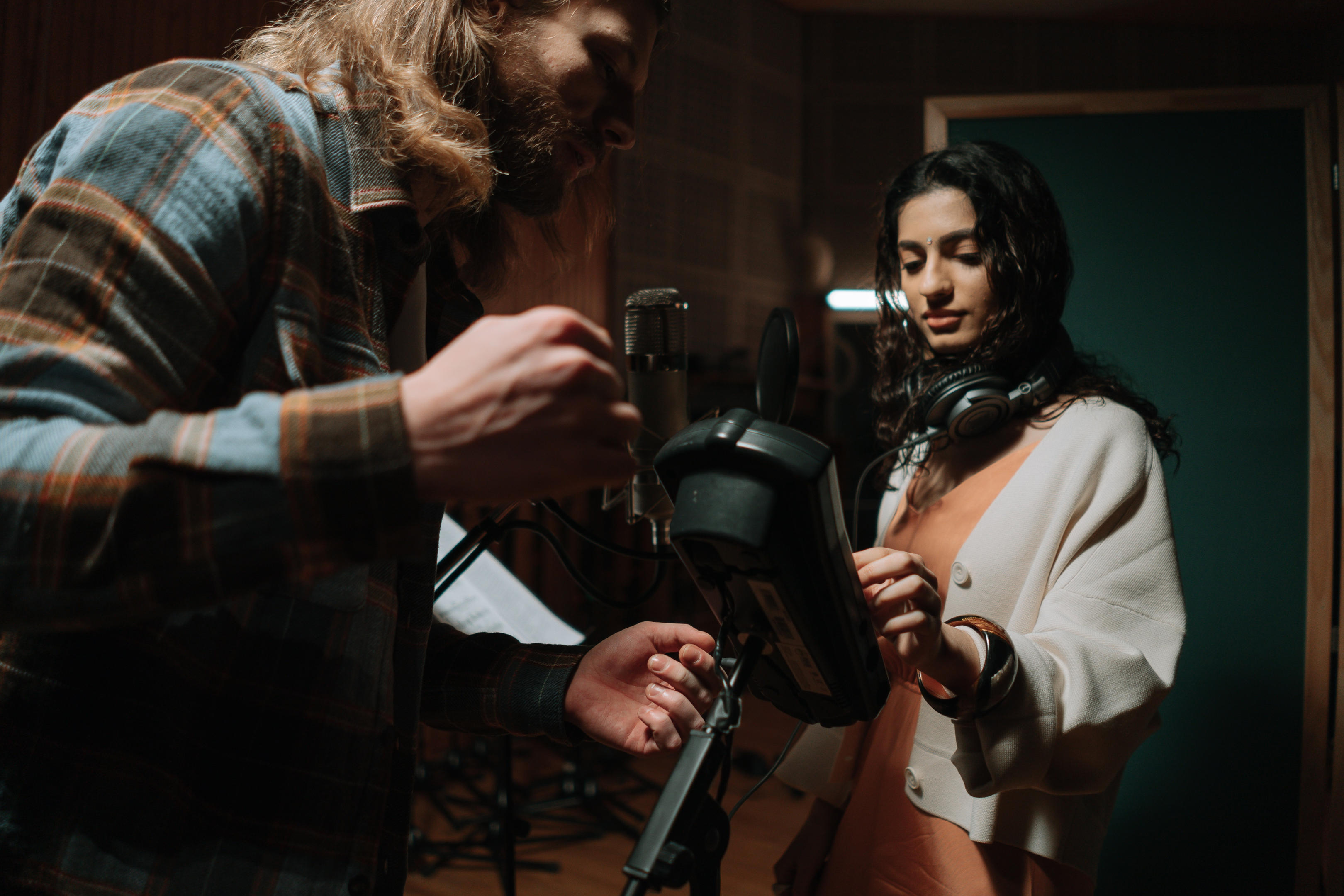 Woman in a recording studio wearing headphones