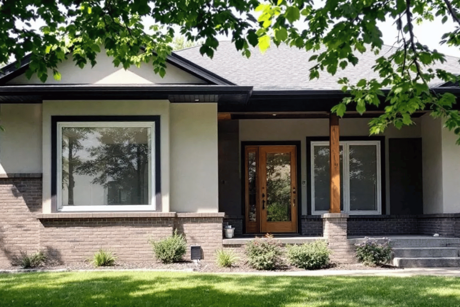 The image features a beautiful home exterior in Columbia, MO, showcasing newly installed replacement windows that enhance its curb appeal. These energy-efficient windows, likely double hung or casement styles, promise better insulation and lower energy bills for homeowners considering a window replacement project.