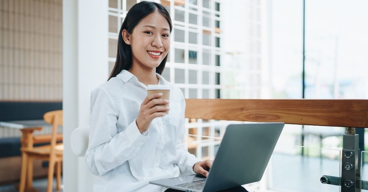 A business owner managing her OnlyFans tax filing with a laptop, focusing on essential small business tax tips.