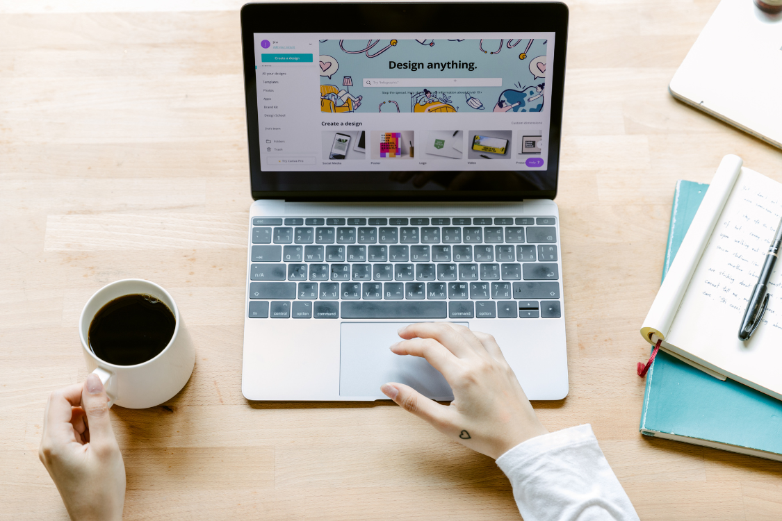 Filipino virtual assistant working remotely on Canva with coffee and planner