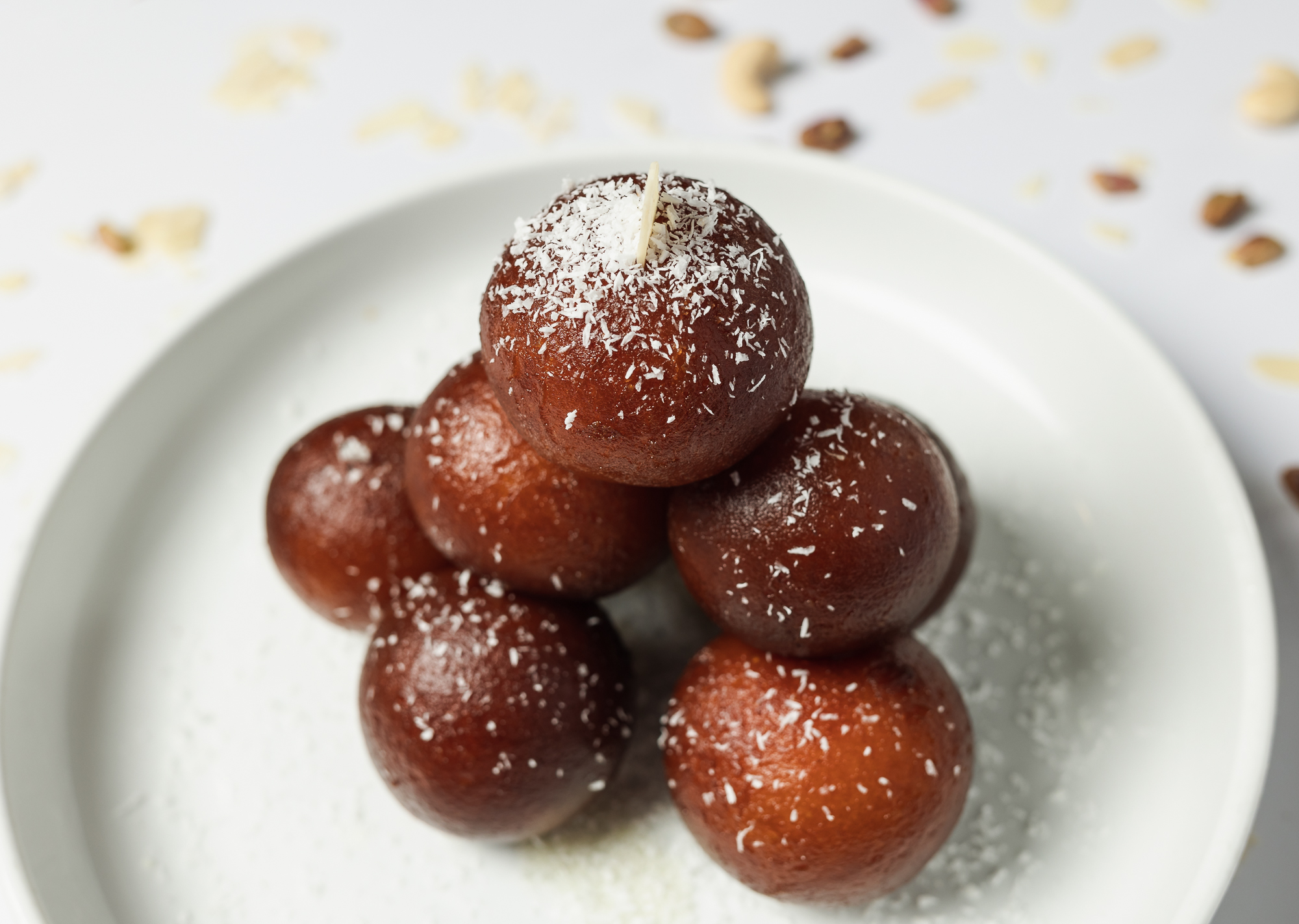 Assortment of Indian sweets including gulab jamun and jalebi