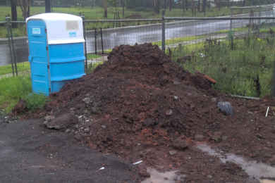 After some excavation work a pile of dirt is left on-site awaiting disposal above ground level