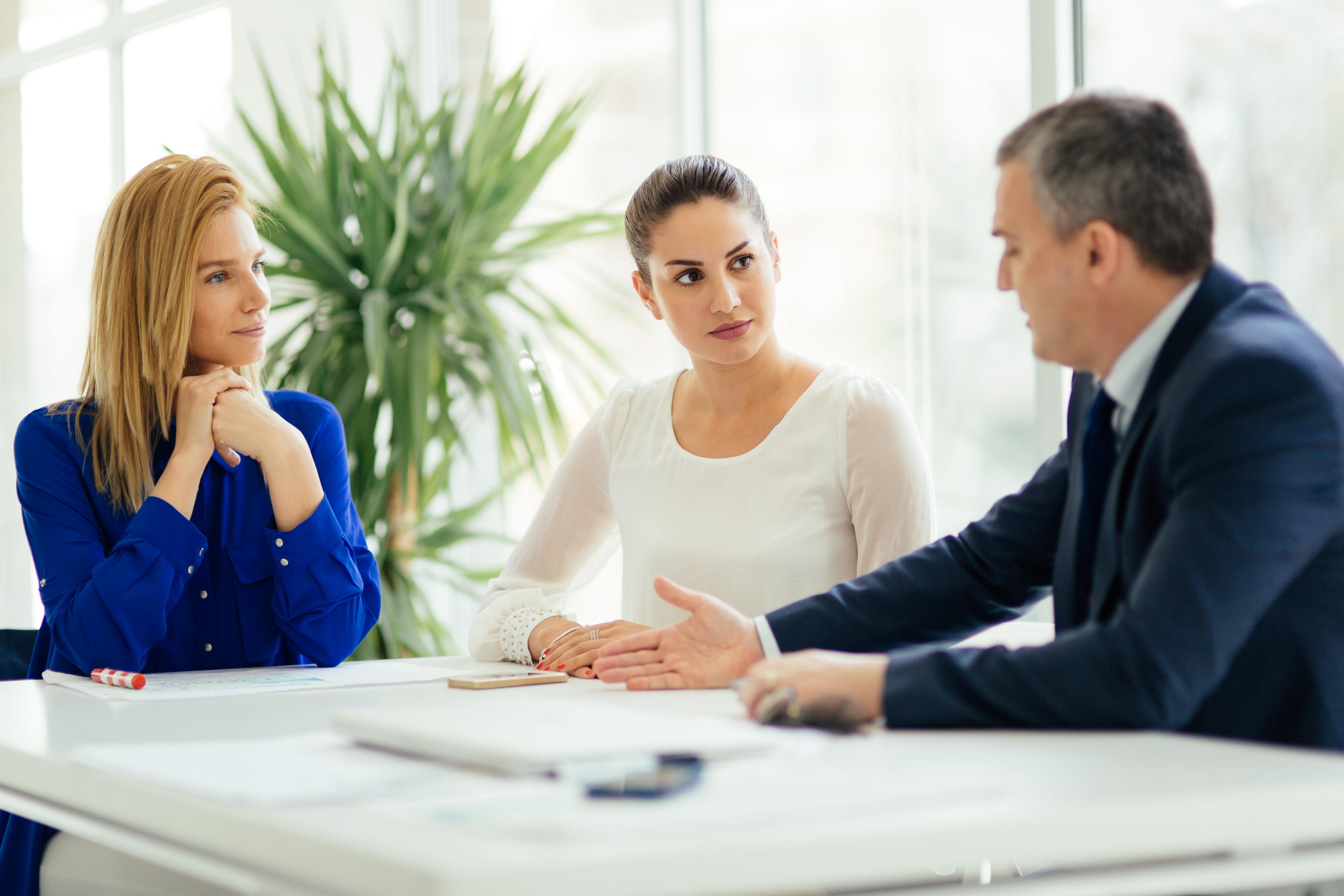 Clients meeting with a lawyer to discuss legal options at an office desk