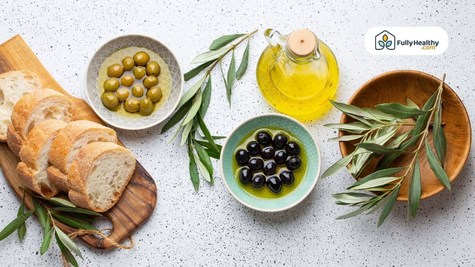 Bread slices, olives, and extra virgin olive oil served for dipping