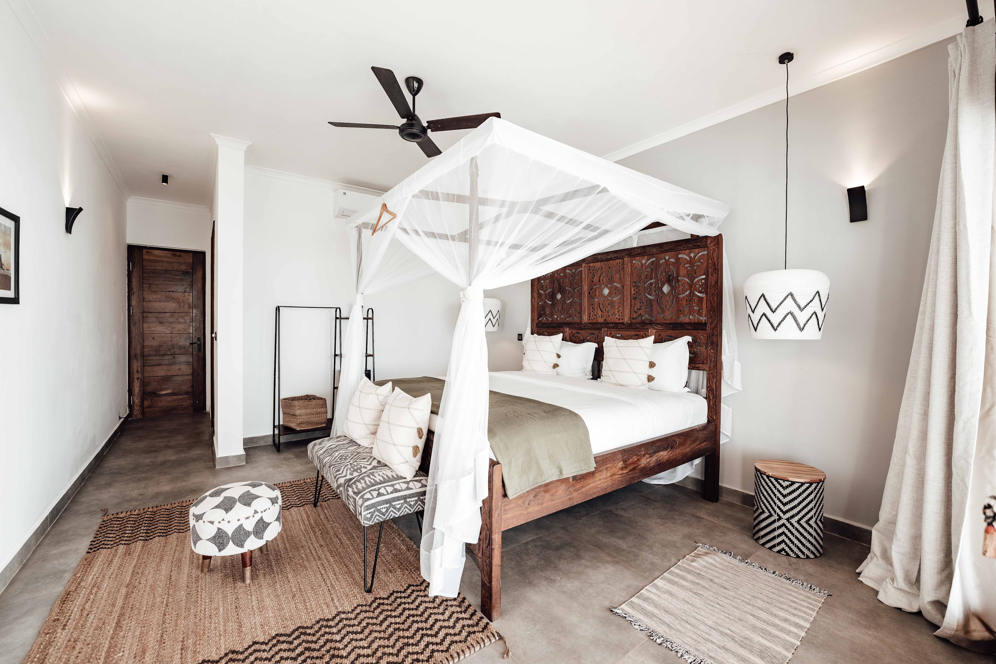 image credit: https://www.pexels.com/photo/wooden-carved-bed-with-white-canopy-and-rugs-in-a-bedroom-12715595/