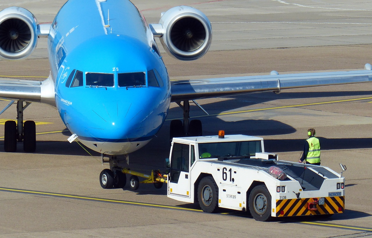 Spot the aircraft mechanic overseeing the pushback operation. 