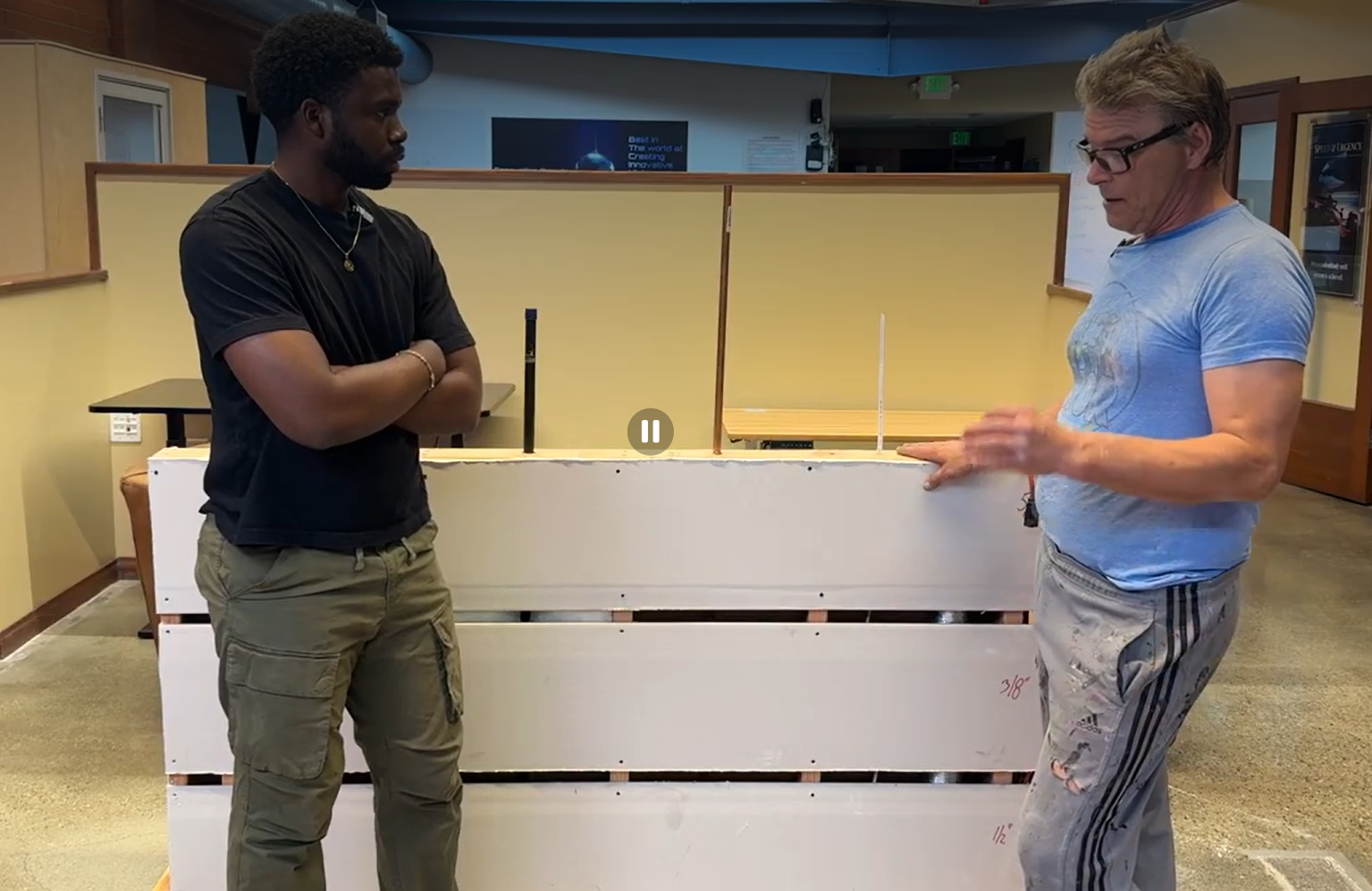 handyman showing how the mock wall was builty