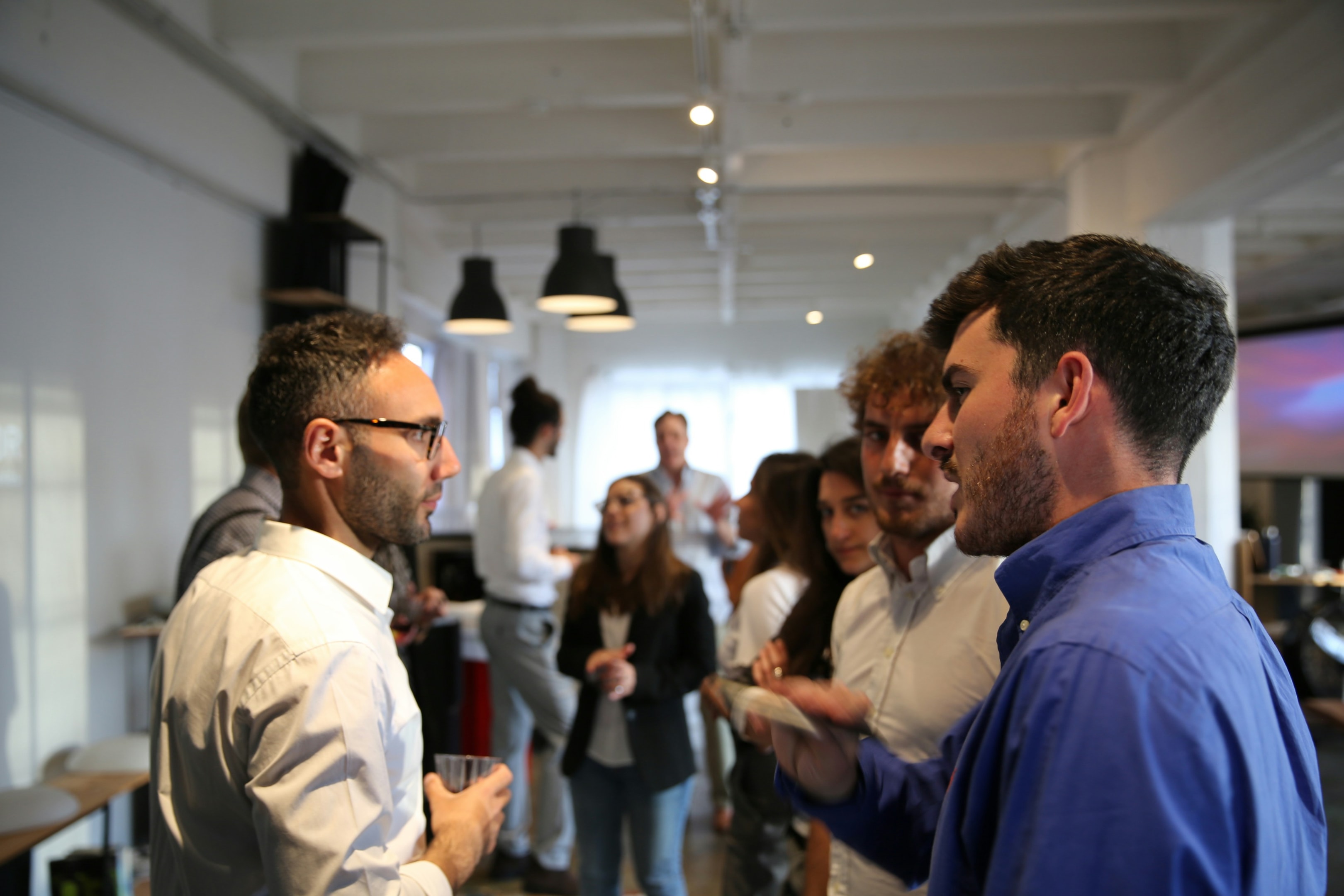 Real estate professionals network at local event. 