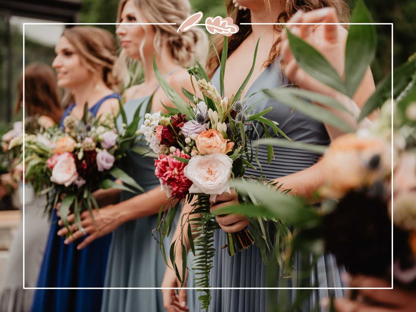 Bridesmaids in elegant dresses holding colorful bouquets of mixed flowers, ready for the wedding ceremony. Fabulous Flowers and Gifts.