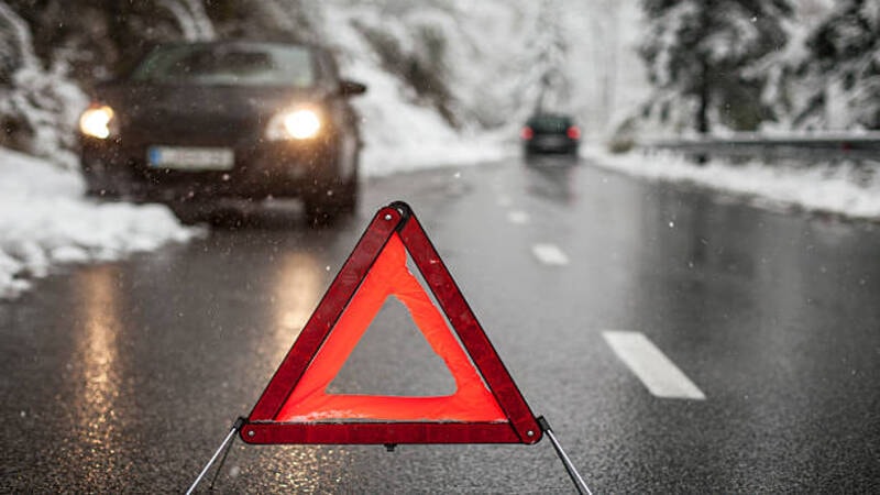 Hazard lights of a car parked on the side of road due to emergency. 